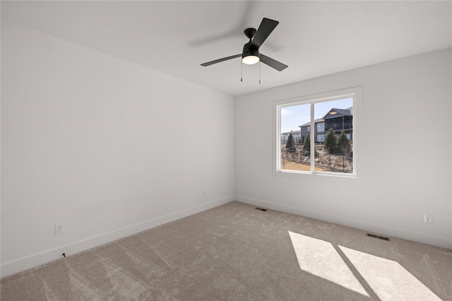 spare room with visible vents, baseboards, carpet, and a ceiling fan