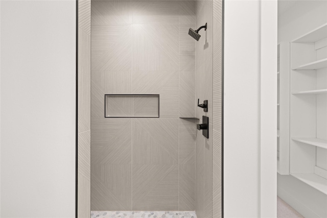 bathroom with a tile shower