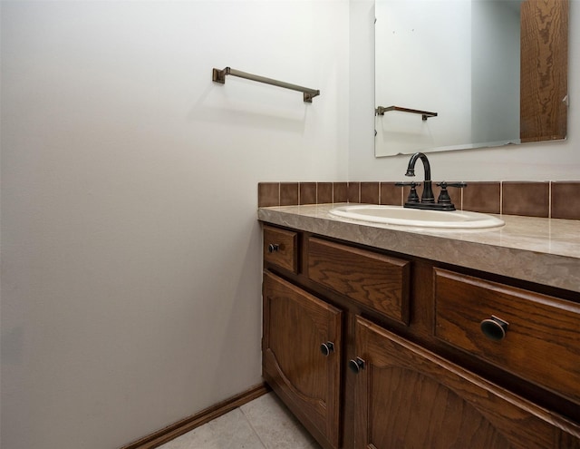 bathroom with tile patterned flooring, vanity, and baseboards