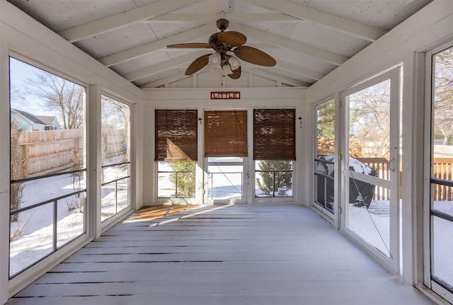 unfurnished sunroom with vaulted ceiling with beams and ceiling fan