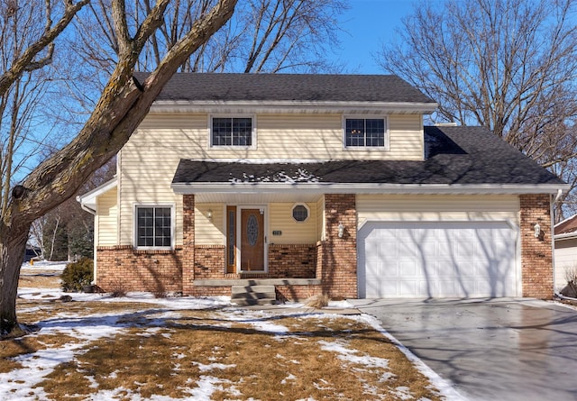 view of front facade featuring brick siding, driveway, an attached garage, and roof with shingles