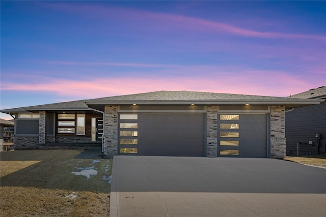10598 NW 72nd Ln, Johnston, IA 50131 - view of front of house featuring driveway, an attached garage, and stone siding