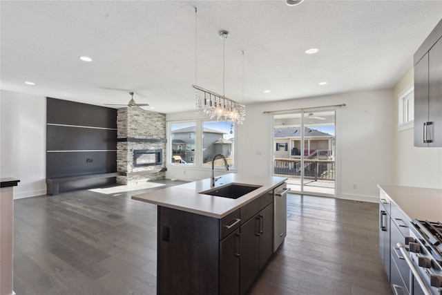 10598 NW 72nd Ln, Johnston, IA 50131 - kitchen with a sink, a ceiling fan, dark wood-style flooring, light countertops, and stainless steel appliances