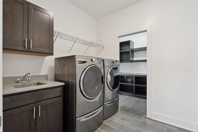 10598 NW 72nd Ln, Johnston, IA 50131 - washroom featuring independent washer and dryer, cabinet space, and wood tiled floors