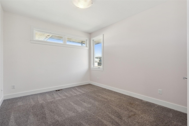 empty room with carpet and baseboards