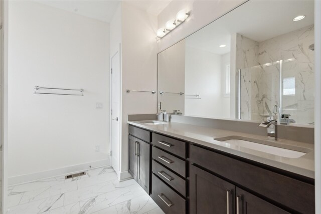 10598 NW 72nd Ln, Johnston, IA 50131 - full bathroom with double vanity, marble finish floors, a marble finish shower, recessed lighting, and baseboards