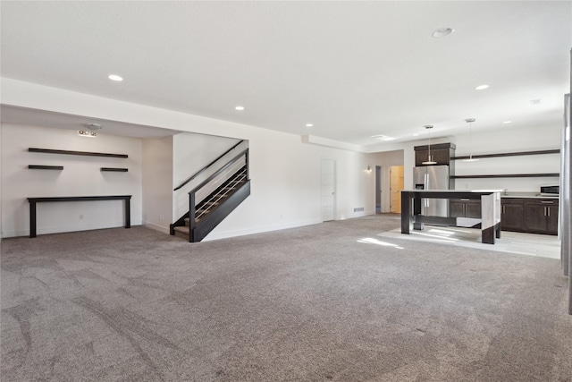 unfurnished living room with recessed lighting, visible vents, light carpet, baseboards, and stairs