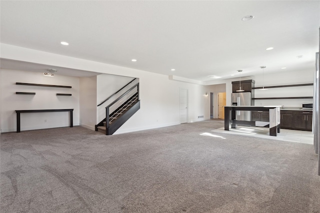 10598 NW 72nd Ln, Johnston, IA 50131 - unfurnished living room featuring light colored carpet, stairway, recessed lighting, and baseboards