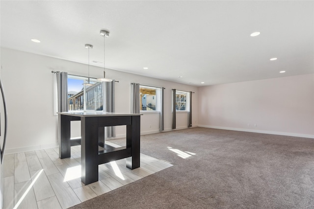 interior space with light carpet, baseboards, and recessed lighting