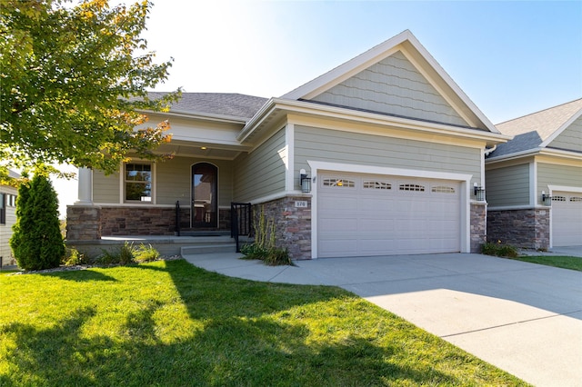 craftsman-style house with concrete driveway, stone siding, an attached garage, covered porch, and a front yard