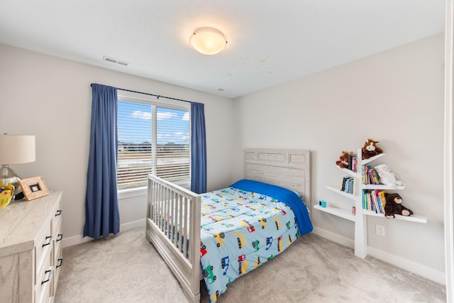 bedroom featuring baseboards, visible vents, and light colored carpet