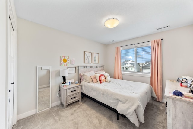 bedroom with light carpet, visible vents, and baseboards