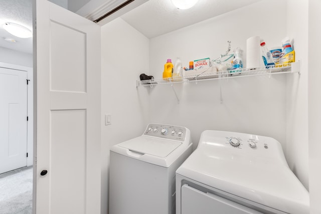 laundry area with light carpet, laundry area, and washer and dryer