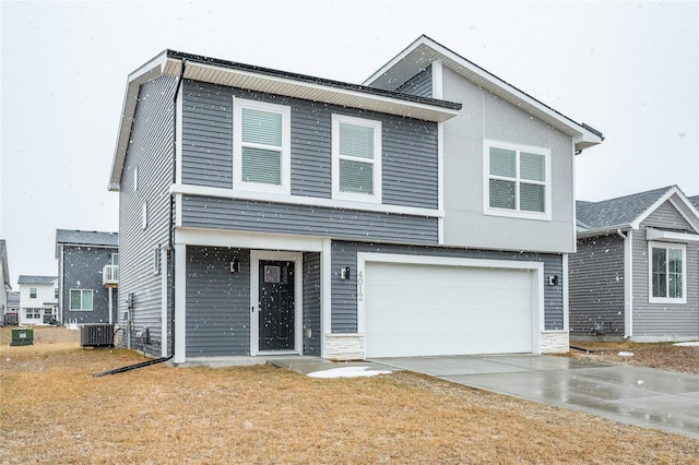 view of front of home featuring driveway, stone siding, an attached garage, and central AC unit