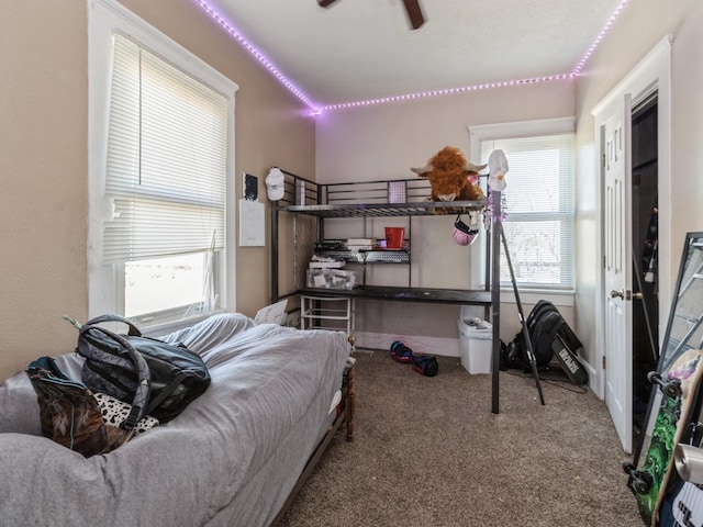 bedroom with carpet flooring, multiple windows, and ceiling fan