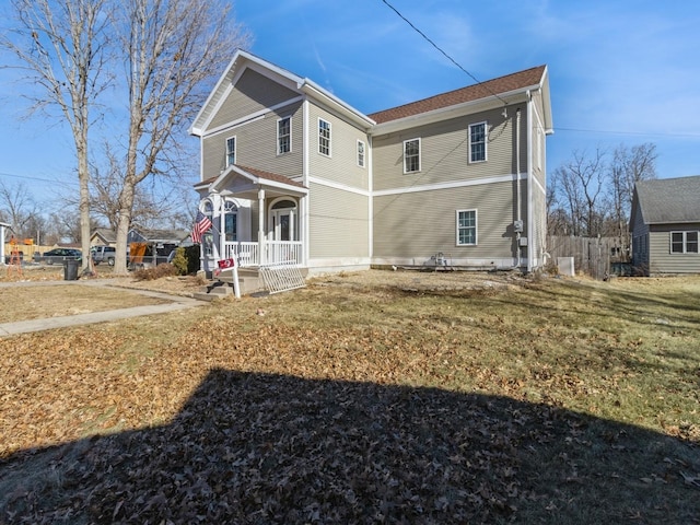 view of property exterior featuring a porch and a yard