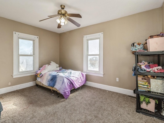 bedroom featuring baseboards, carpet floors, and a ceiling fan