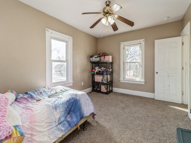 bedroom featuring ceiling fan, baseboards, and carpet