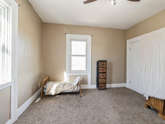 unfurnished room featuring baseboards, ceiling fan, and carpet flooring