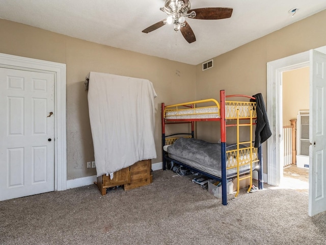 bedroom featuring a ceiling fan, carpet, and visible vents