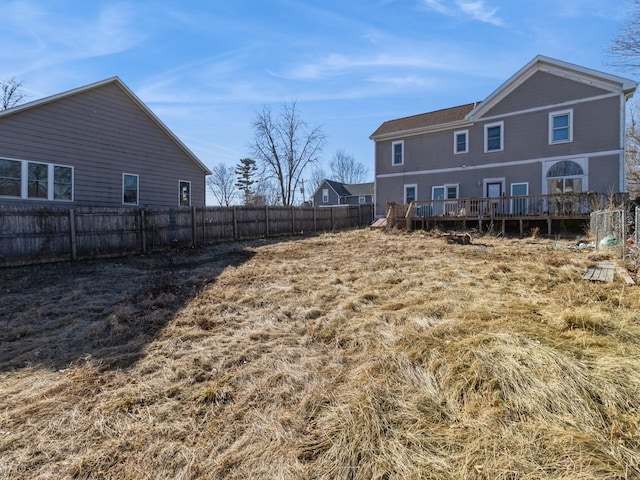 view of yard with a deck and fence