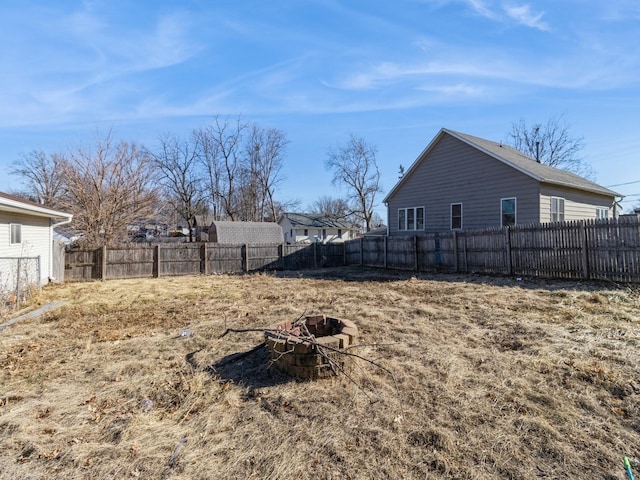 view of yard featuring an outdoor fire pit and a fenced backyard