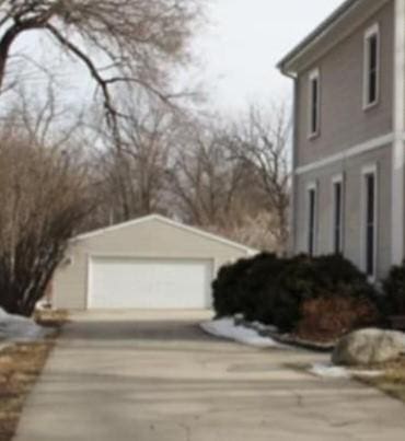 view of property exterior with an outbuilding and a garage