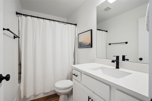 full bathroom featuring toilet, shower / tub combo, wood finished floors, vanity, and visible vents