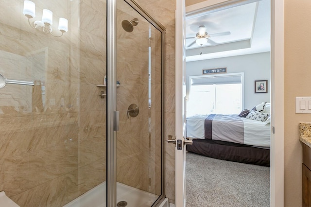 ensuite bathroom with a ceiling fan, a stall shower, vanity, and ensuite bathroom