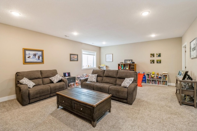 carpeted living room featuring visible vents, baseboards, and recessed lighting