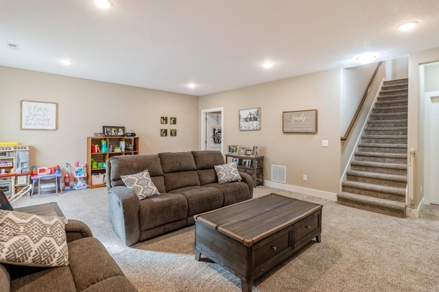 carpeted living area with stairway, baseboards, visible vents, and recessed lighting