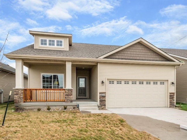 craftsman inspired home featuring a porch, stone siding, driveway, and an attached garage