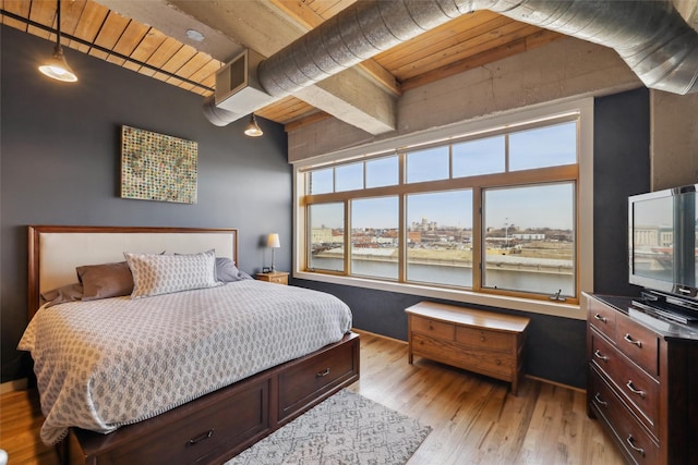 bedroom with wood ceiling, light wood-style flooring, and beam ceiling