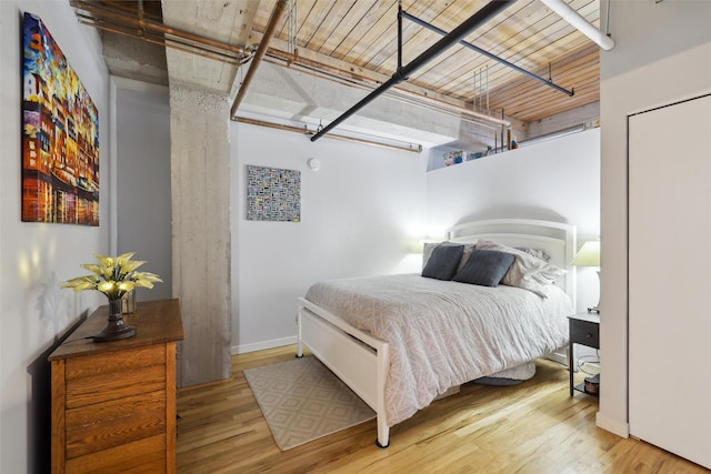 bedroom featuring baseboards and wood finished floors