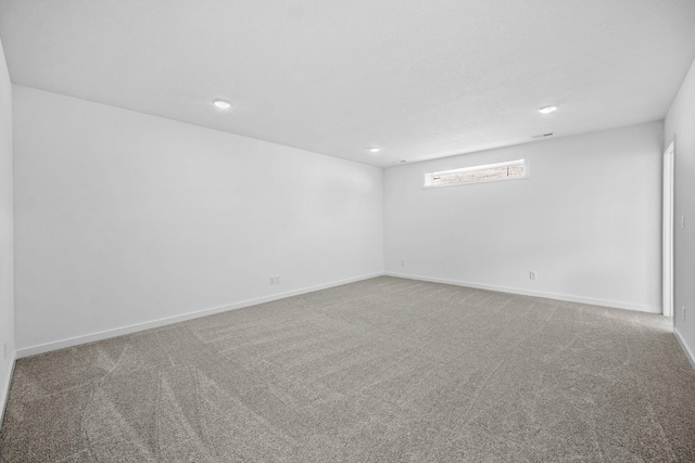 carpeted empty room with recessed lighting and baseboards