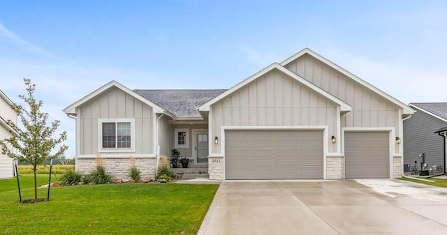 view of front facade featuring a garage, driveway, a front lawn, and board and batten siding