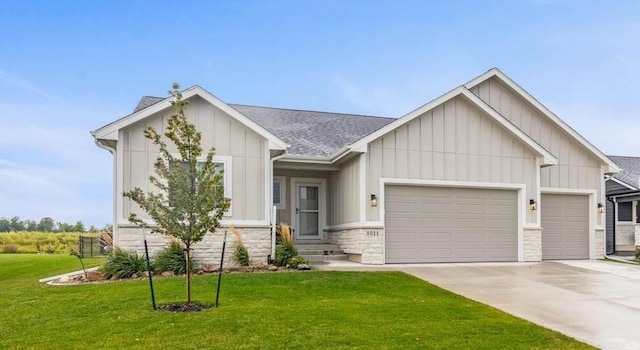 view of front of home with a garage, concrete driveway, board and batten siding, and a front yard