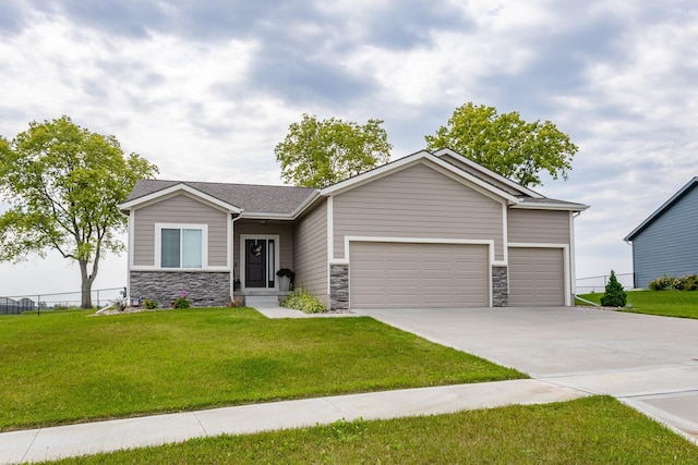 view of front of house featuring a garage, stone siding, a front lawn, and concrete driveway