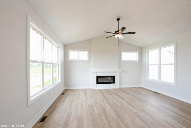 2908 Yordi Dr, Norwalk, IA 50211 - unfurnished living room featuring light wood-style floors, ceiling fan, a glass covered fireplace, baseboards, and vaulted ceiling