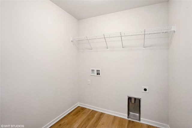 2908 Yordi Dr, Norwalk, IA 50211 - washroom featuring hookup for an electric dryer, washer hookup, light wood-style flooring, and baseboards