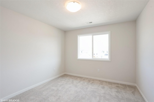 2908 Yordi Dr, Norwalk, IA 50211 - unfurnished room with light carpet, baseboards, and a textured ceiling