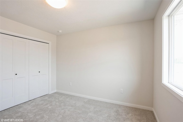 2908 Yordi Dr, Norwalk, IA 50211 - unfurnished bedroom featuring carpet, a closet, and baseboards