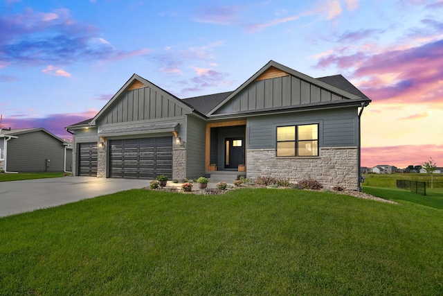 craftsman inspired home with a garage, concrete driveway, board and batten siding, and stone siding