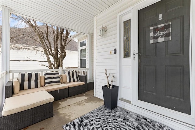 property entrance with a porch and outdoor lounge area