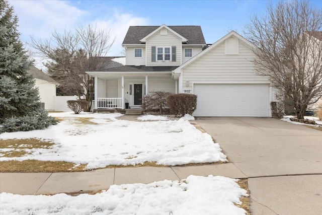 view of front of property featuring driveway, covered porch, and an attached garage