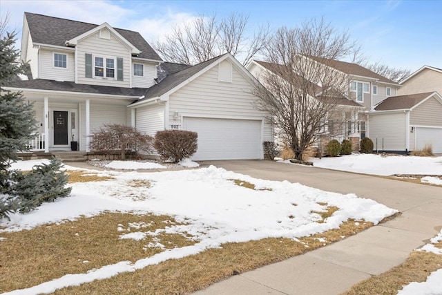 view of front of property with a shingled roof, covered porch, driveway, and a garage