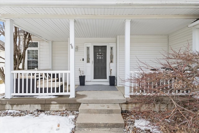 view of exterior entry featuring a porch