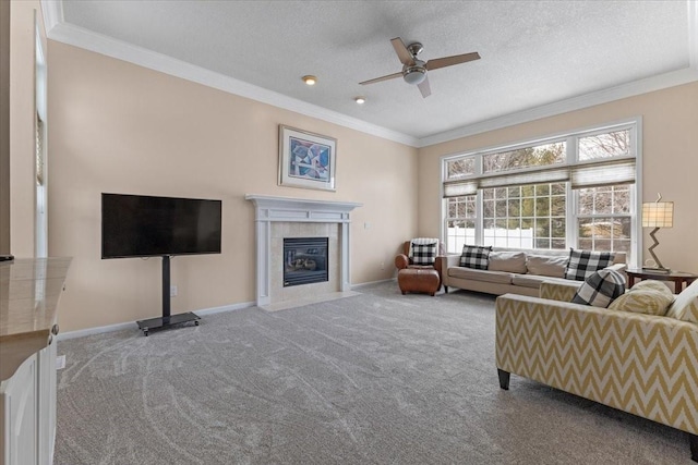 carpeted living area with baseboards, ornamental molding, a textured ceiling, and a tile fireplace