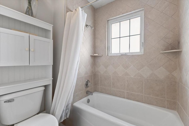 bathroom featuring shower / bath combo and toilet