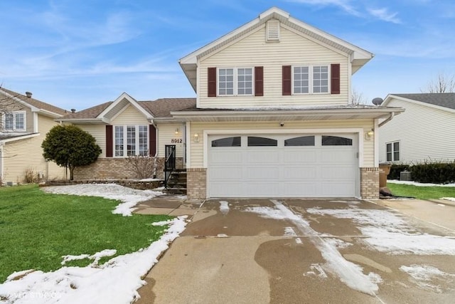 view of front of house featuring a garage, a front yard, concrete driveway, and brick siding